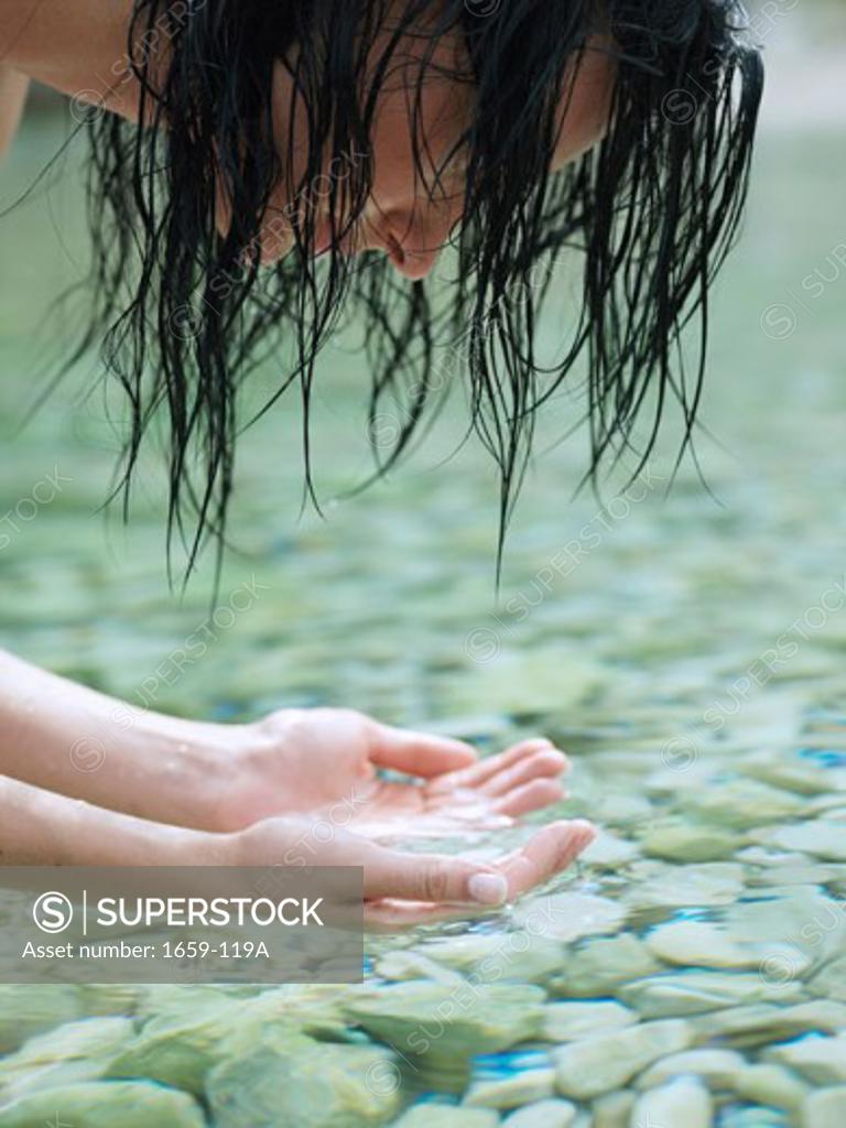 Stock Photo: 1659-119A Close-up of a young woman washing her face