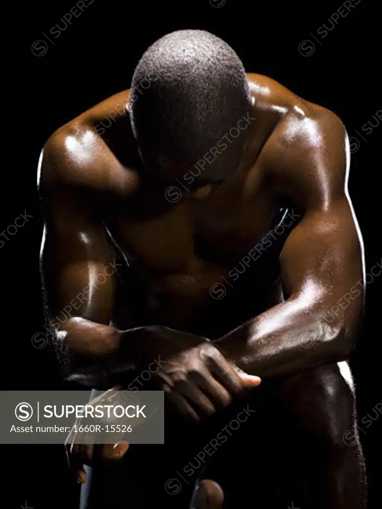 Muscular athlete in dark room