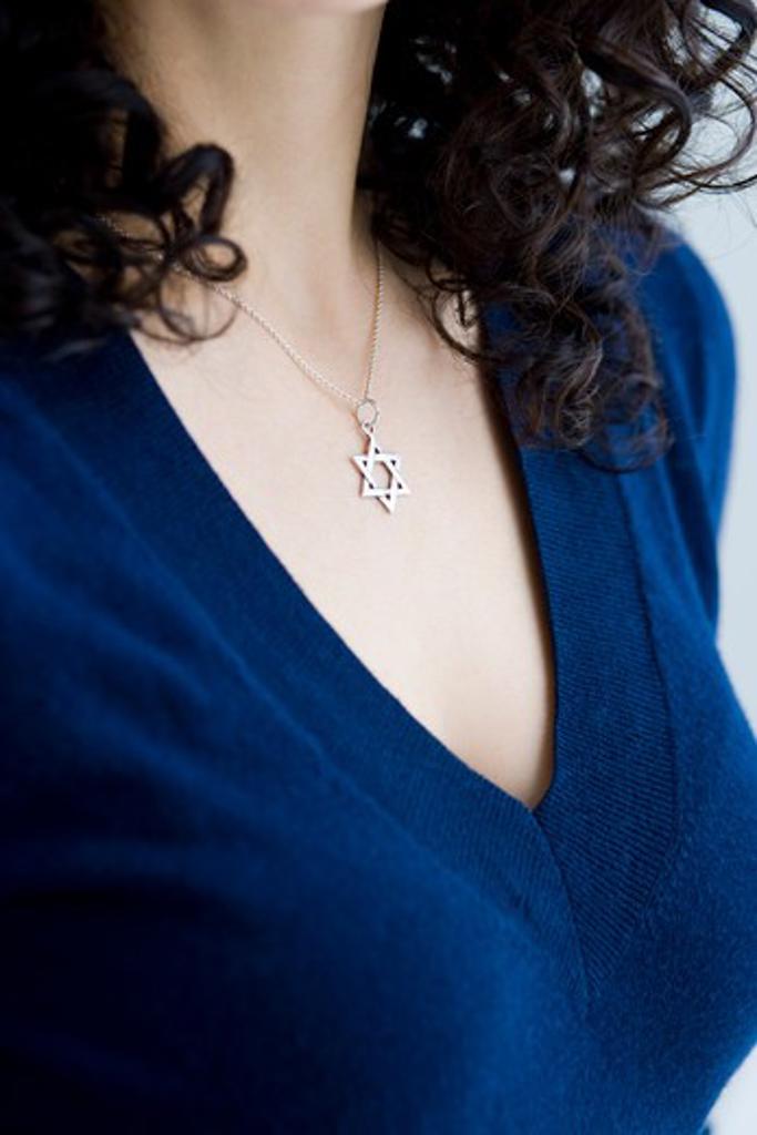 woman wearing a star of david necklace