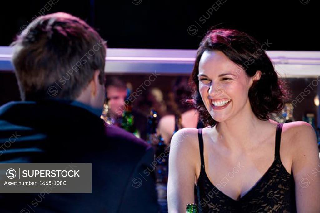 Stock Photo: 1665-108C Close-up of a female bartender looking at a young man and smiling