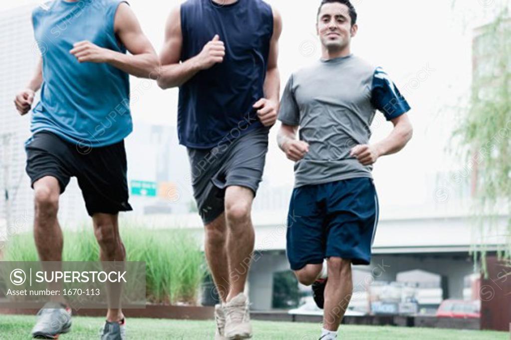 Stock Photo: 1670-113 Close-up of three young men jogging