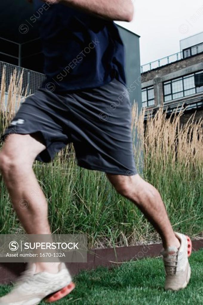 Stock Photo: 1670-132A Low section view of a young man jogging