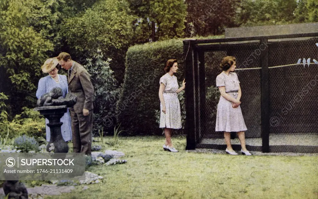 Colour photograph of King George VI (1895-1952), the Queen Mother (1900-2002), Queen Elizabeth II (1926 -) and Princess Margaret (1930-2002) in the gardens of Windsor Castle. Dated 20th Century