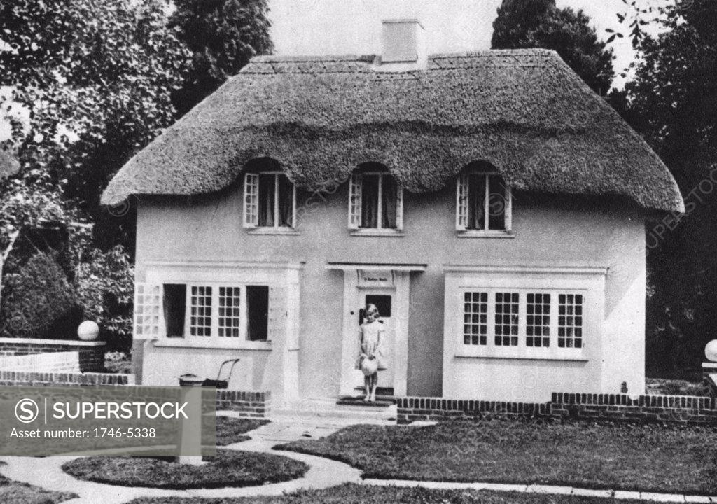 Stock Photo: 1746-5338 Princess Elizabeth (Elizabeth II of Great Britain from 1952) as a child on the steps of Y Bwthn Bach (The Little House) the play house given by the people of Wales