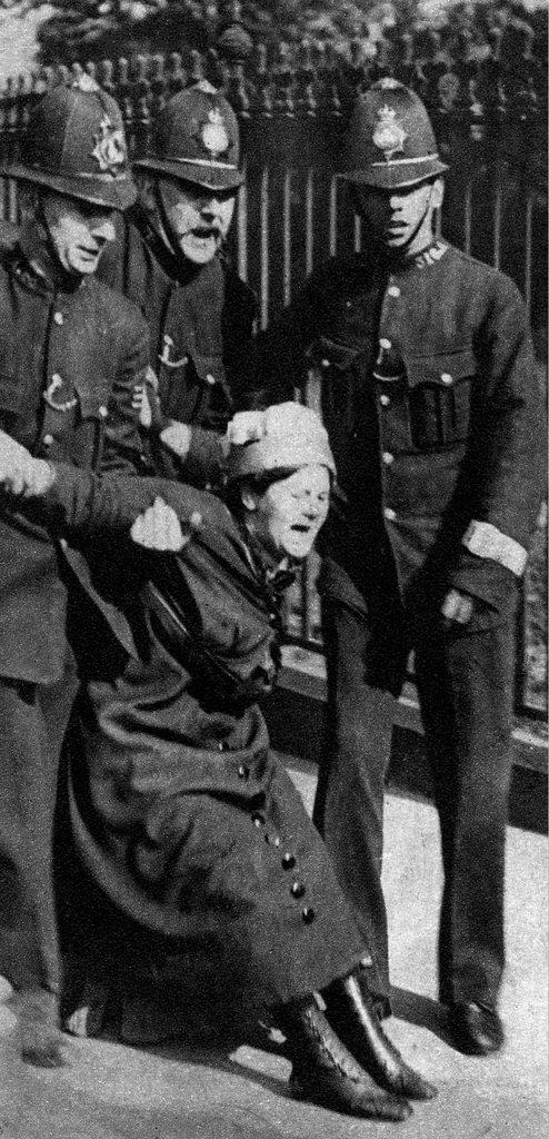 Suffragette being restrained by the police.