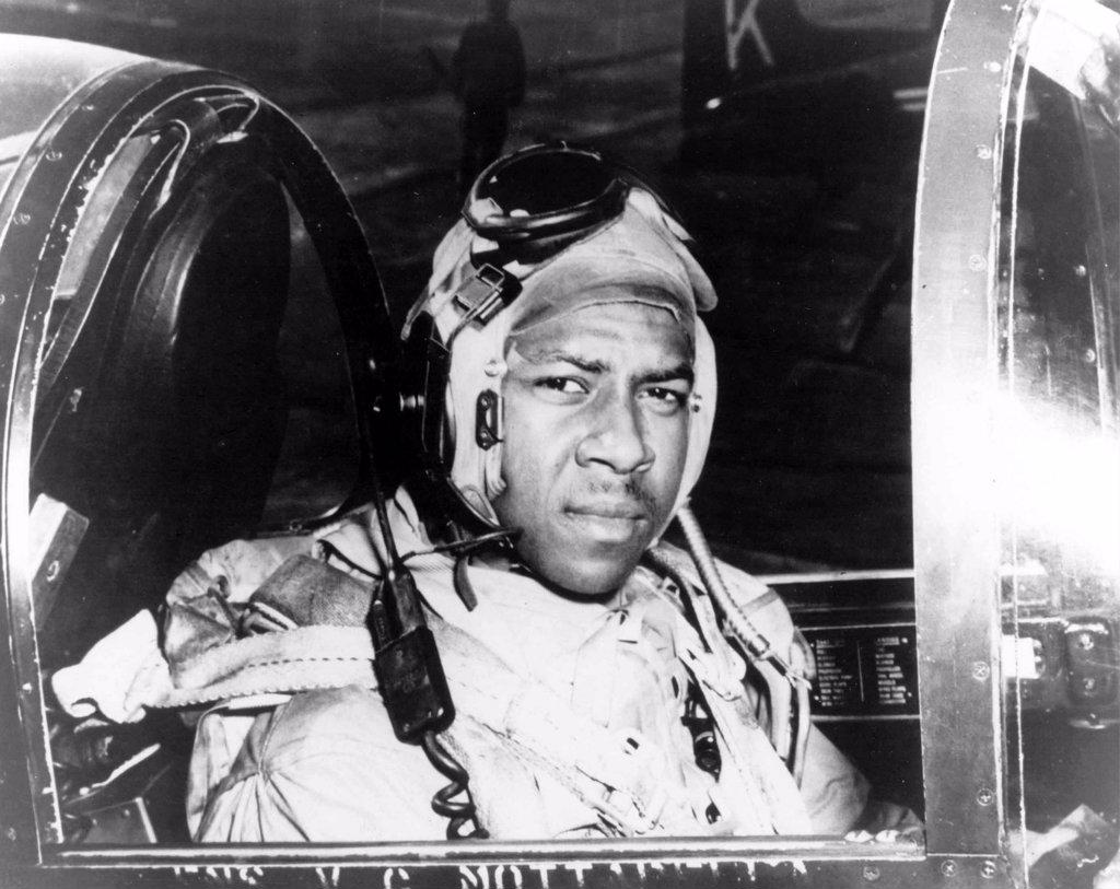 Ensign Jesse L. Brown, seated in the cockpit of an F4U-4 Corsair Fighter plane, the U.S. Navyís first black naval aviator. While in Korea, he was killed in action and posthumously awarded the Distinguished Flying Cross.