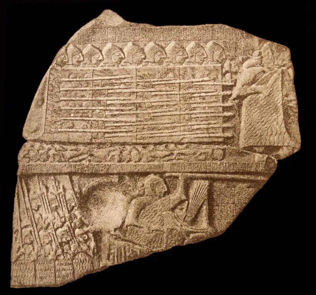 Ancient Babylonian carvings depicting a Babylonian soldier and a collection of weapons