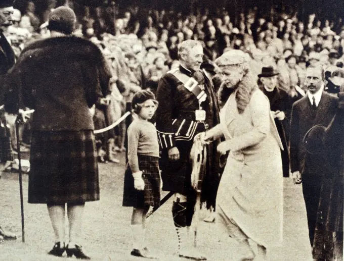 Photograph of arrival of King George V and Queen Mary of Teck arriving for the Highland Games. Princess Elizabeth is in the foreground. Dated 1935