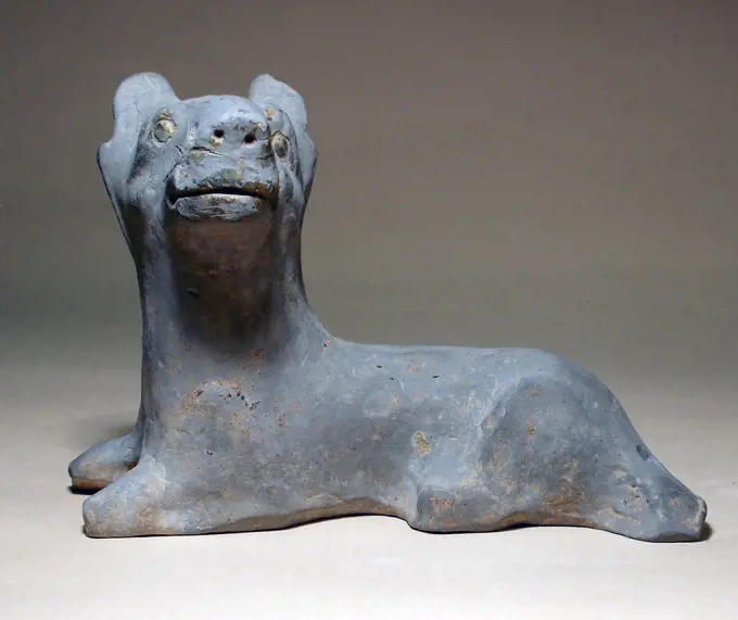 Ancient China: Reclining guard-dog, grey pottery, Eastern Han Dynasty, 24 - 220 AD.