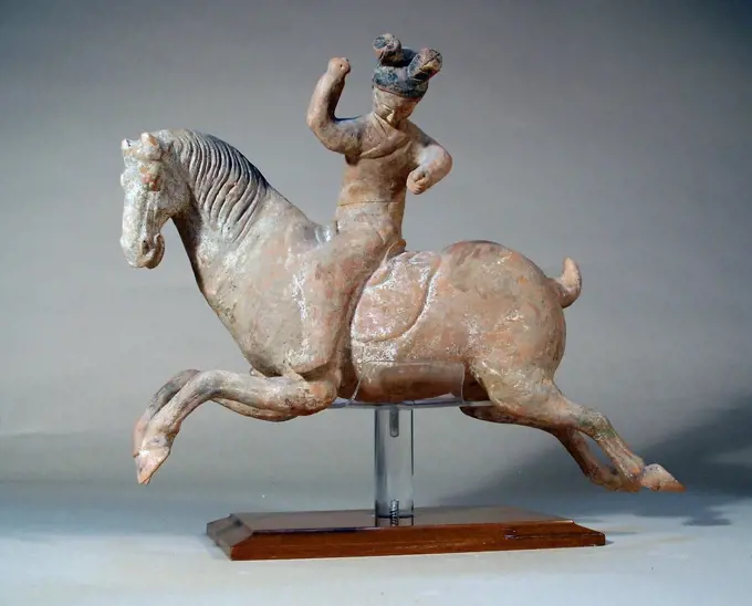 Ancient China: Galloping horse with polo-playerr, Tang Dynasty, 618 -906 AD. Unglazed pottery.