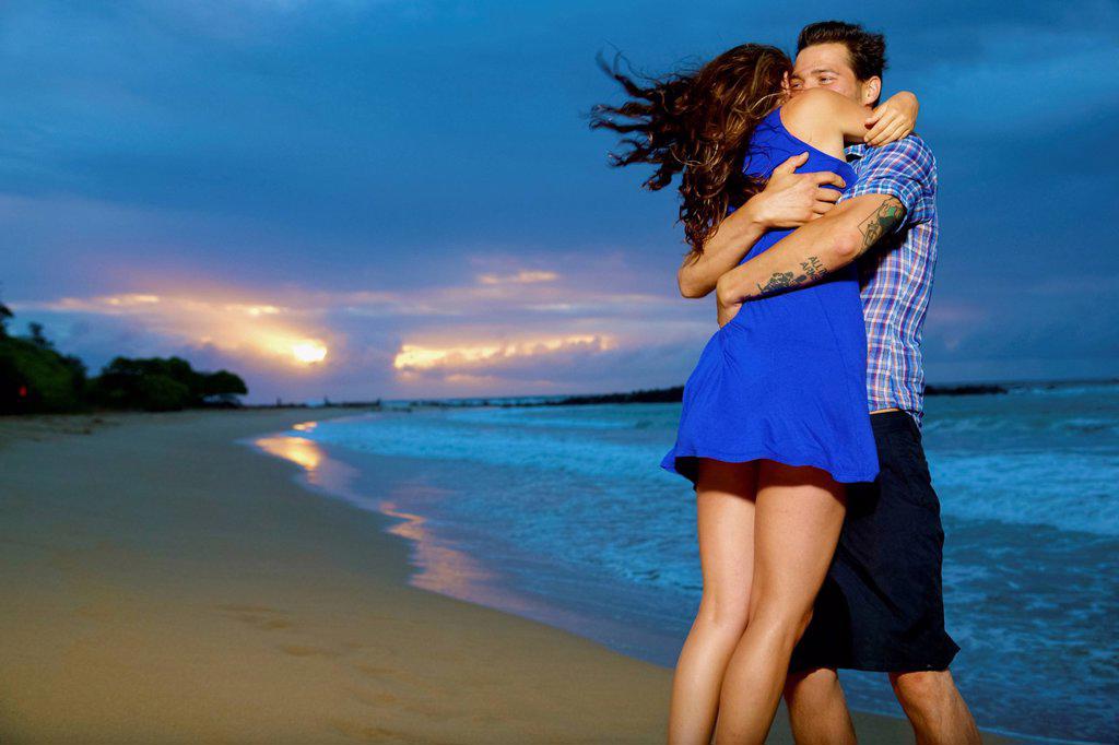 Couple on a beach; Kealia, Kauai, Hawaii, United States of America