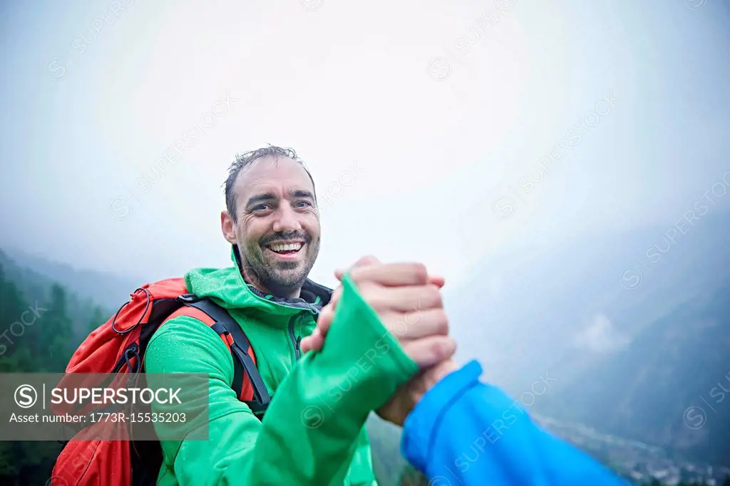 Hikers congratulating themselves, Mont Cervin, Matterhorn, Valais, Switzerland