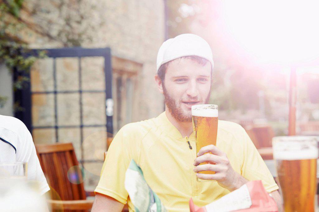 Cyclist in beer garden in pub