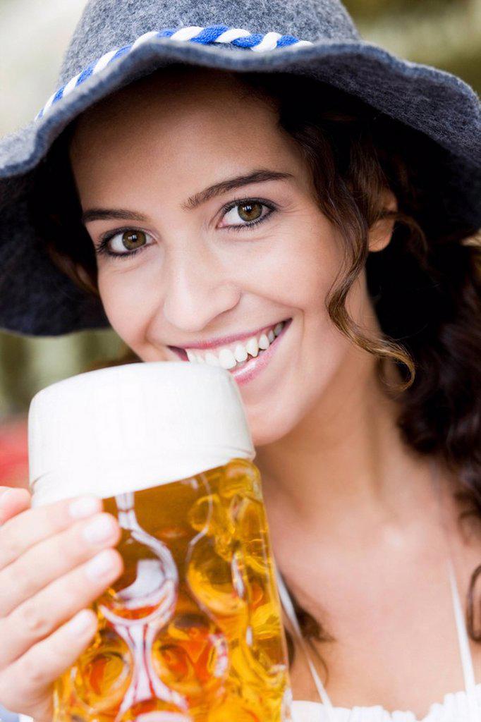 Young Woman With Hat Drinking Beer