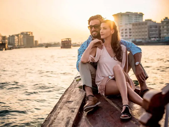 Romantic couple sitting on boat at Dubai marina, United Arab Emirates