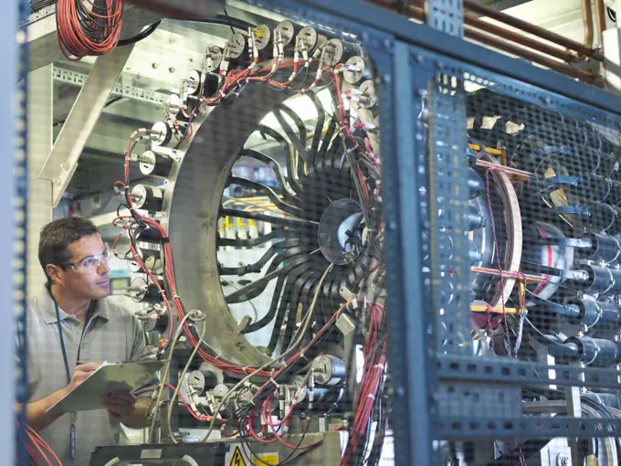 Scientist inspects particle accelerator