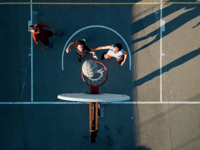 Overhead view of friends on basketball court playing basketball game