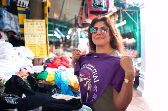 Woman looking at souvenirs on market stall, Bangkok, Krung Thep, Thailand, Asia