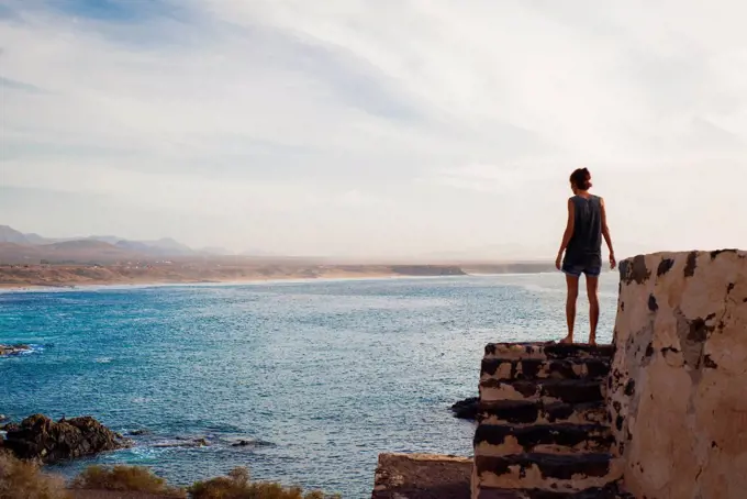 Woman looking out to sea, Corralejo, Fuerteventura, Canary Islands