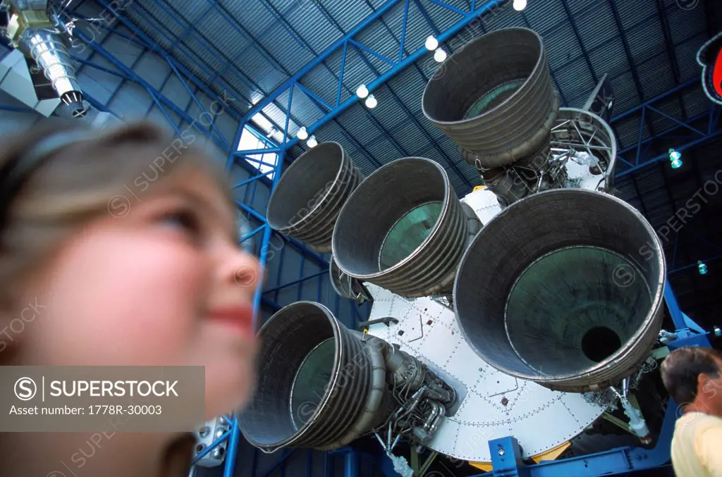 Girl next to Rocket Engines, Cape Canaveral, Kennedy Space Center, Florida, USA.