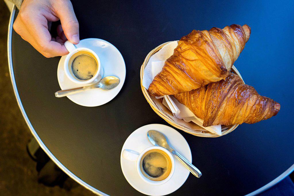 Espresso and Croissants in a basket on a table at a brasserie in Saint Michel, Paris, France