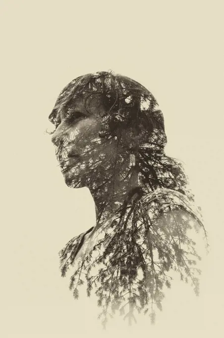 In-camera double exposure of woman and trees.