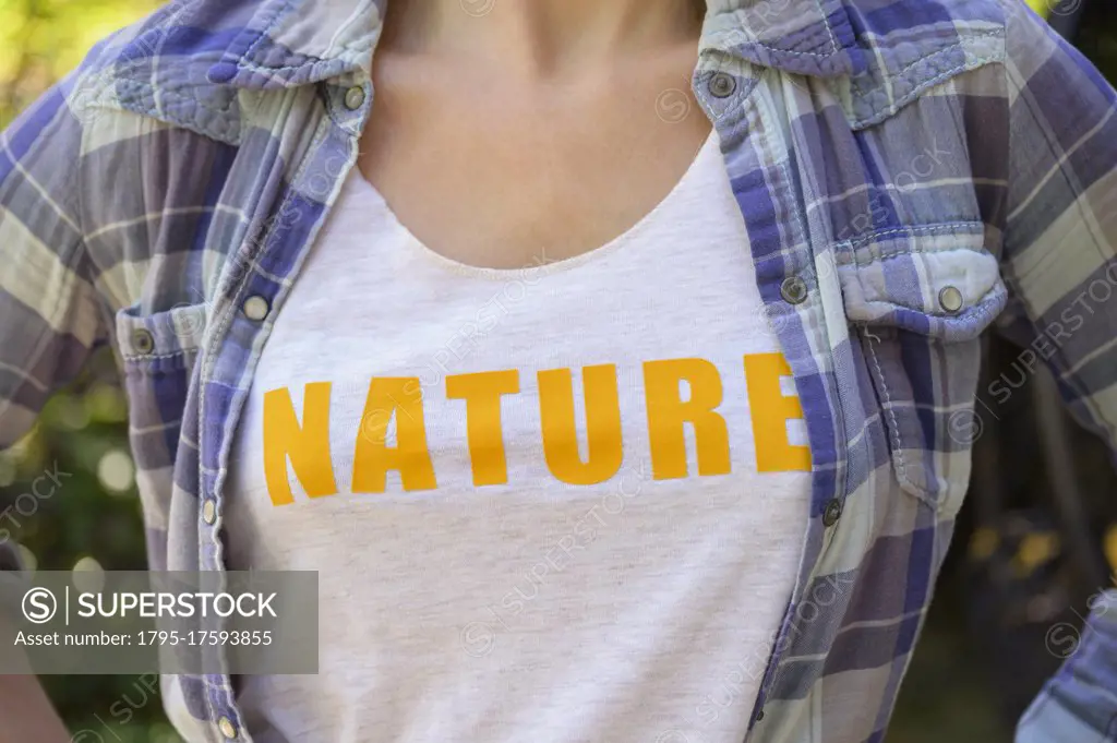 Midsection of girl (6-7) wearing nature t-shirt