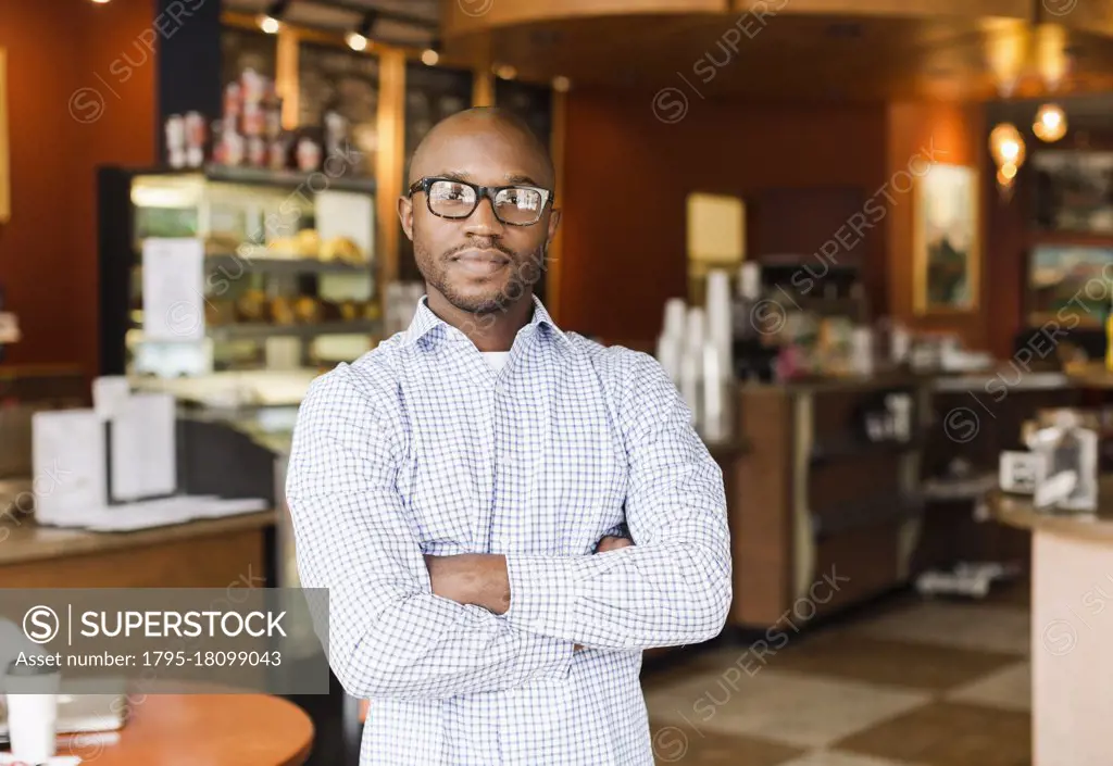 Black man standing in coffee shop