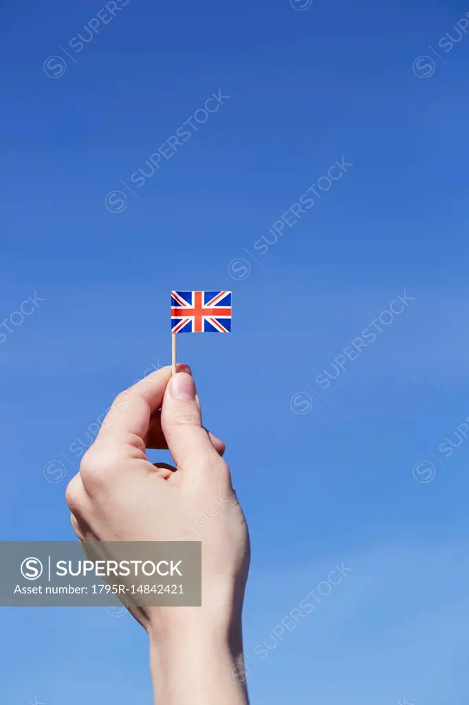 Woman holding British flag in hand