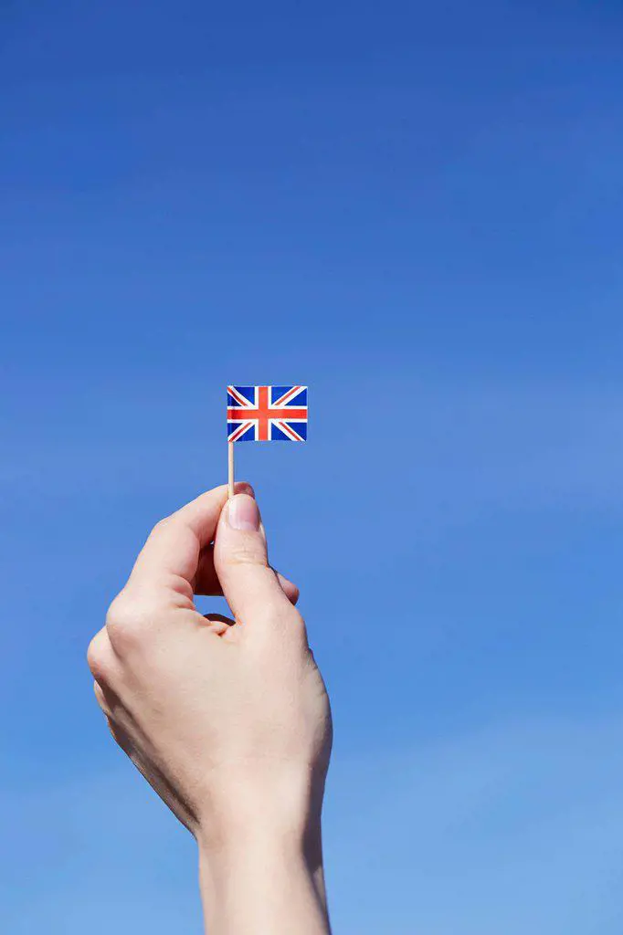 Woman holding British flag in hand
