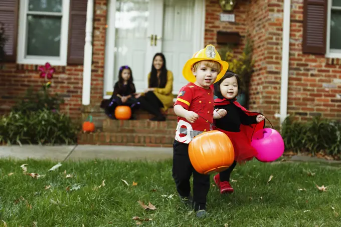 Boy dressed as fireman with trick or treat bucket