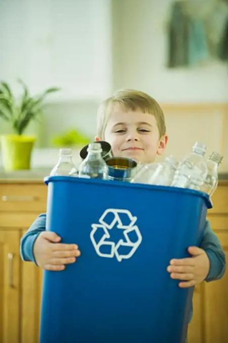 Boy carrying full recycling bin