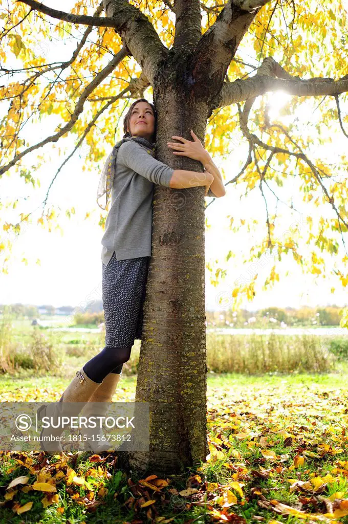 Portrait of women tree hugging