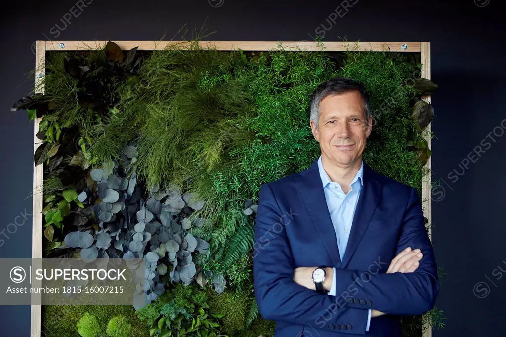 Portrait of confident businessman in green office