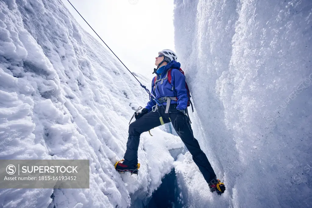 Female mountaineer in crevasse, Glacier Grossvendediger, Tyrol, Austria