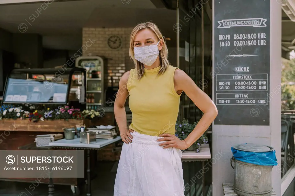 Portrait of confident cafe owner wearing face mask