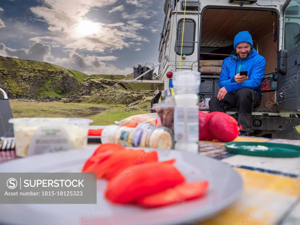 Male traveler camping with motor home at Holaskjol-Higlandcenter