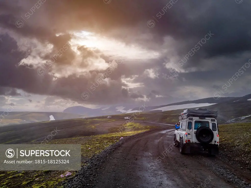 Dramatic sky over off-road car driving along remote dirt road at¶ÿFjallabak Nature Reserve