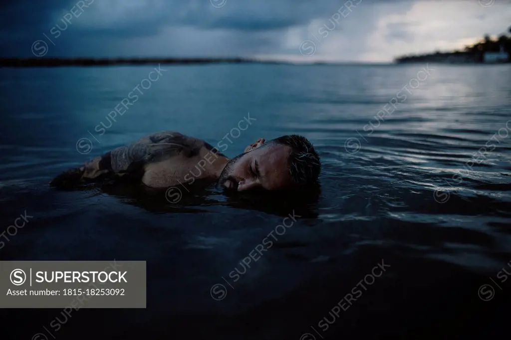 Mid adult man floating on water