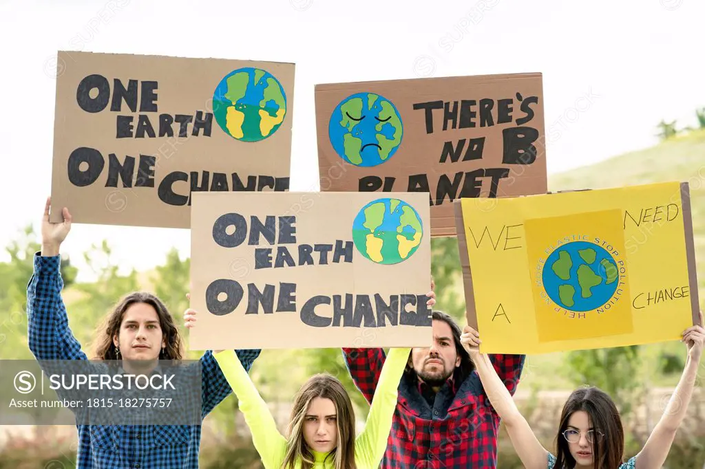 Protestor holding climate change alertness posters