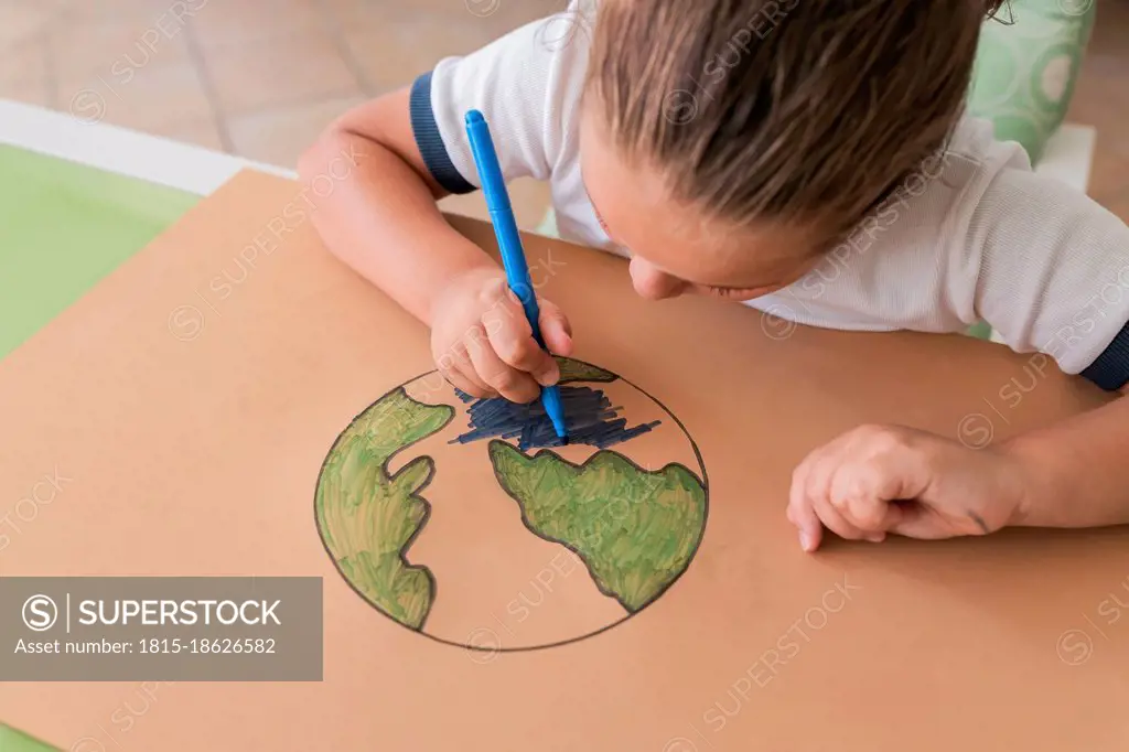Girl coloring Earth planet sketch at home