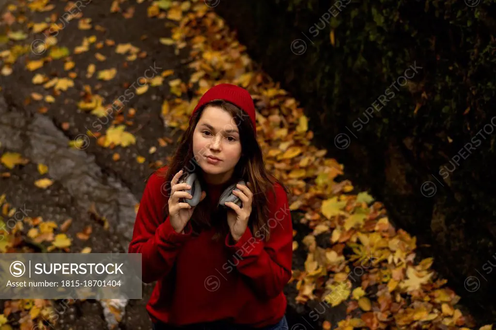 Beautiful woman with headphones in public park