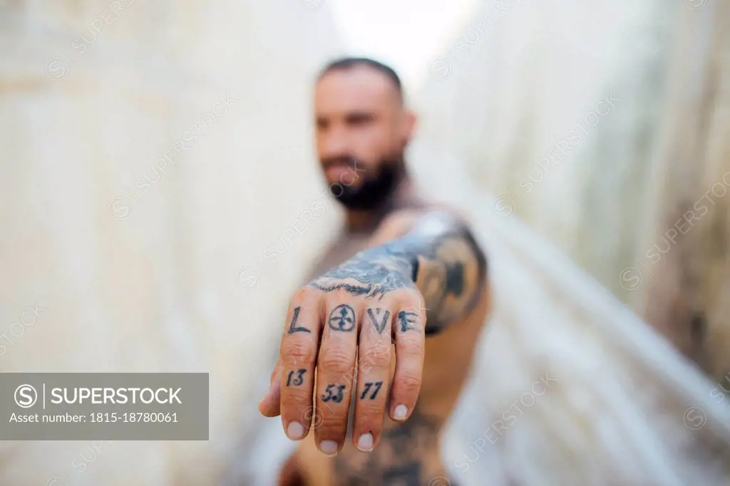 Man showing tattooed hand