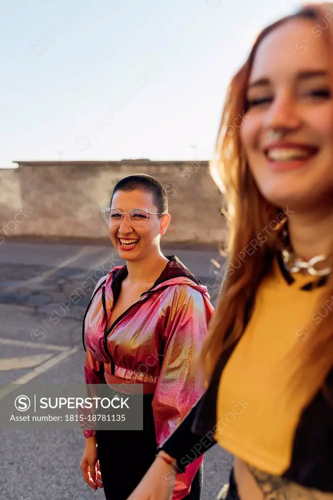 Happy woman standing on road with friend