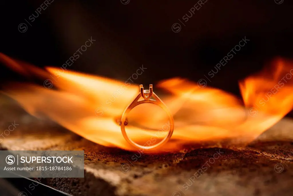 Close-up of burning silver ring in furnace at workshop