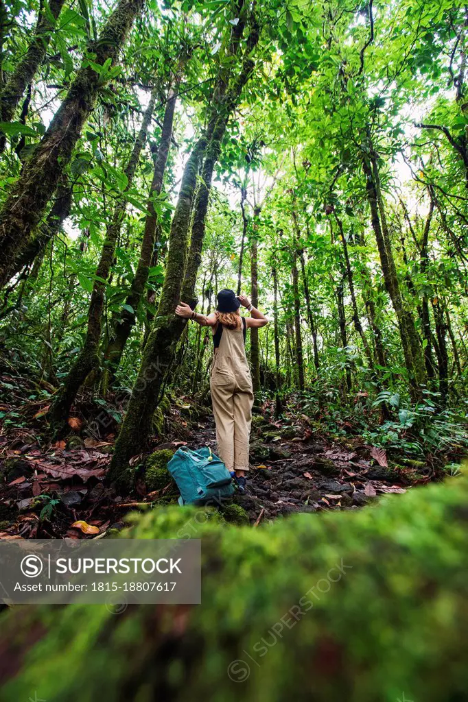 Adventurous woman exploring in forest at Arenal Volcano National Park, La Fortuna, Alajuela Province, Costa Rica