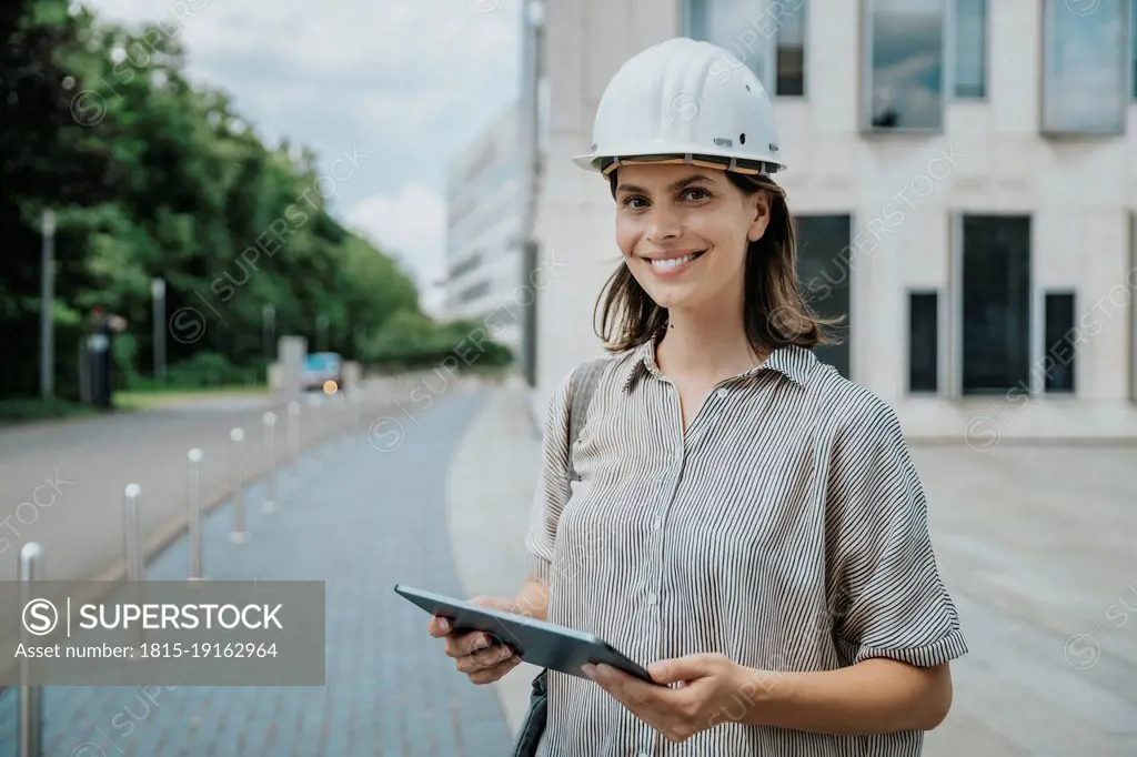 Architect holding tablet PC at construction site