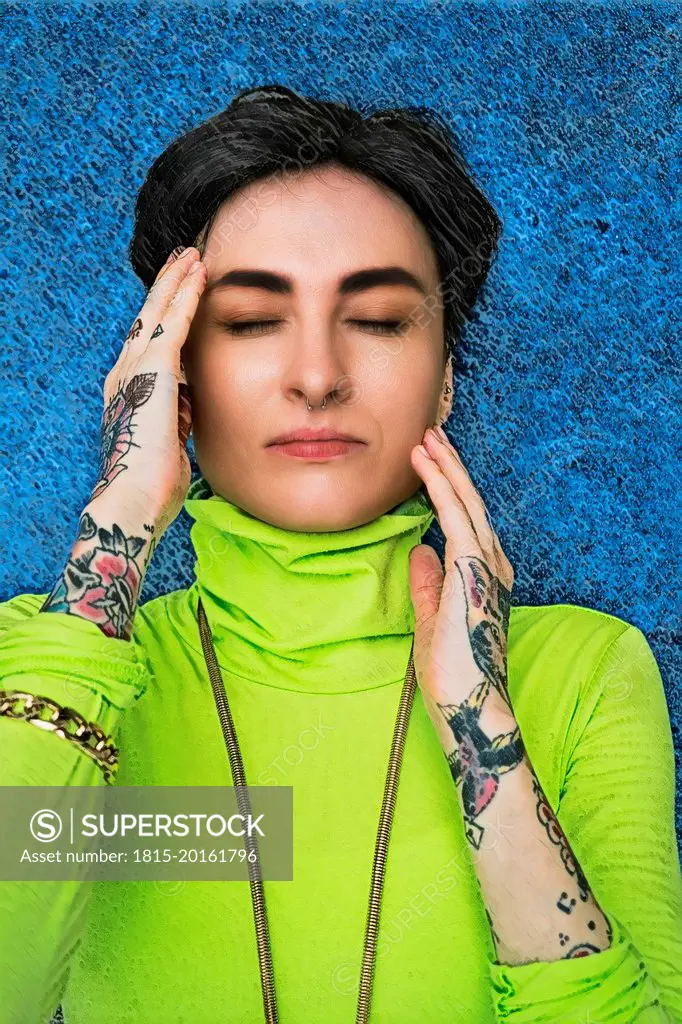 Tattooed hipster woman with eyes closed