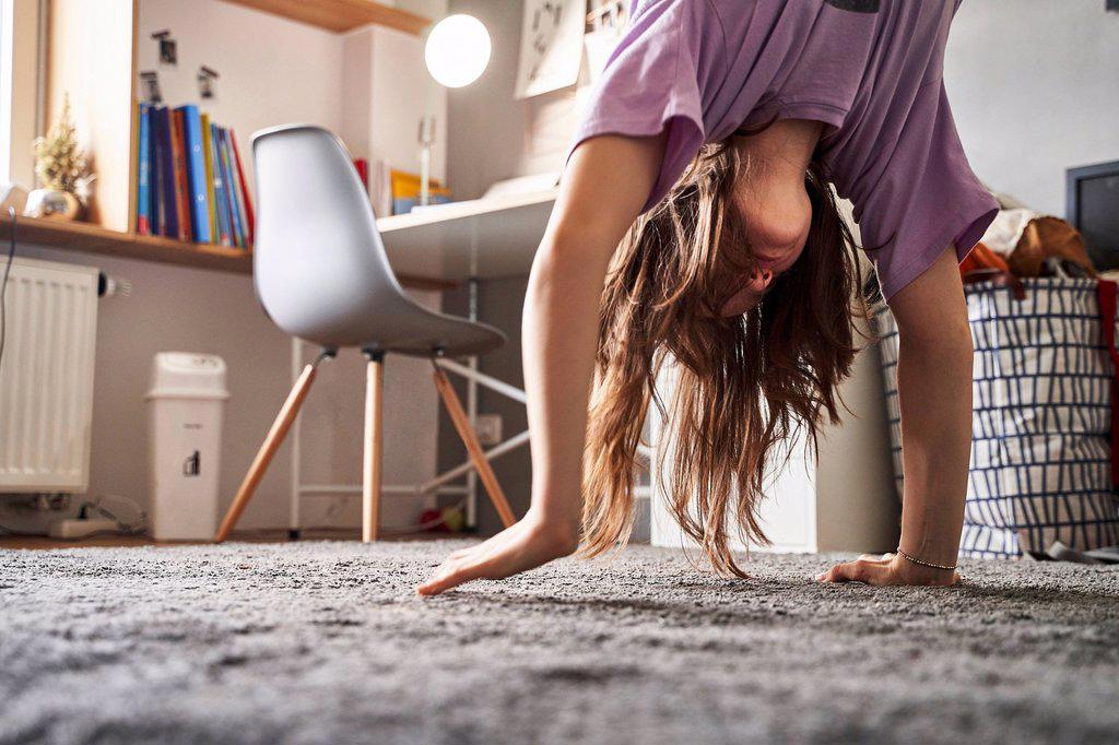 Girl doing handstand at home