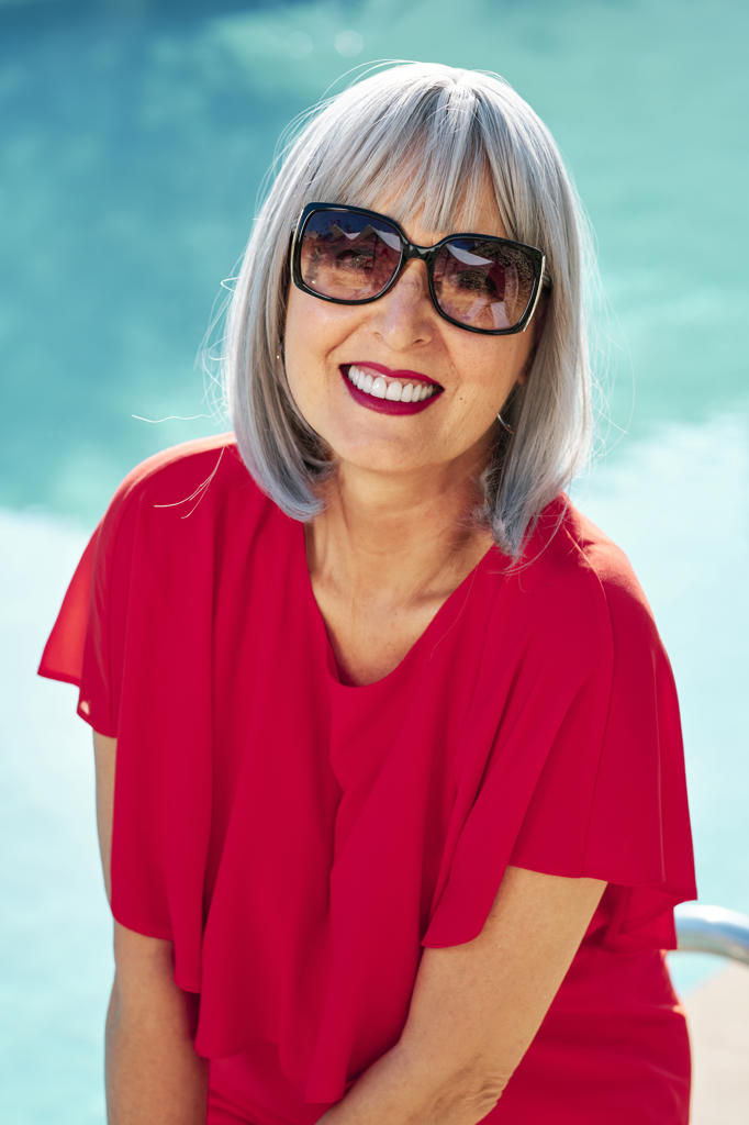 Smiling mature woman wearing sunglasses during sunny day